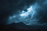 Dramatic storm clouds over the mountains create a moody, atmospheric scene. Ideal for illustrating power, nature's force, or feelings of uncertainty.