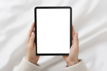Poster - Hands holding a tablet device with a blank screen, resting on a soft, textured surface, ideal for showcasing digital content or design mockups with copy space