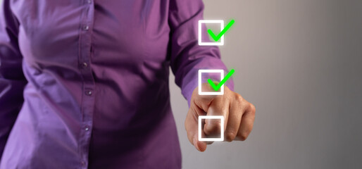 Poster - Businesswoman pointing at a check mark inside a square on a to-do list