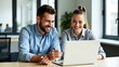 © MdAmin - Two smiling colleagues collaborating effectively on a laptop sharing ideas and working together in a bright modern office environment
