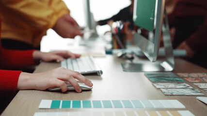 Poster - A vibrant workspace displays a designer actively working on a computer while colleagues engage in discussion, surrounded by colorful materials and creative elements. SACTR