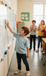 © Irwanto Labs - Young boy proudly cleans whiteboard in classroom while classmates clap in appreciation during a school lesson