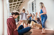 © Marko Geber - Multigenerational caucasian family being playful and having fun on a balcony of their house