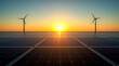 © Ada - Solar panels and wind power generation equipment. solar panel field at sunset, with two large wind turbines silhouetted against the bright sky