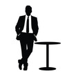 © MD NAZRUL - Silhouette of a businessman in a suit leaning against a table