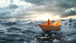 © Tata Design - Orange paper boat navigates turbulent ocean waves under stormy skies. Sunlight breaks through clouds, illuminating fragile vessel