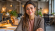 © Shivani - A young indian woman in her early 20s sits at a sleek, modern desk in a tastefully designed office space, framed in a medium close-up shot.