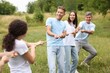 © New Africa - Team building. Group of happy people playing tug of war with rope outdoors