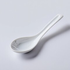 Poster - A simple white ceramic spoon, isolated on a pure white background. Kitchenware, minimalist.