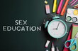 © New Africa - Sex Education inscription and stationery on green chalkboard, top view