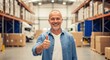 © Farhan - Portrait of a happy mature logistics manager giving an enthusiastic thumbs-up in a large distribution warehouse. Symbol of approval and successful operations.