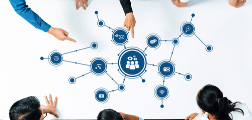 Poster - diverse individuals engage in a collaborative discussion, pointing at digital icons representing var