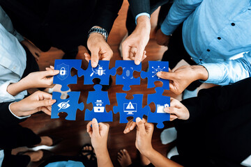 Poster - A diverse group of professionals collaboratively assembles blue puzzle pieces, each symbolizing critical aspects of security, strategy, and innovation in modern business environments. Amity