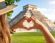 © Dea - Hands forming heart around pyramid