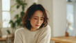 © bephoto - 女性が窓辺で涙をこぼす