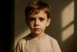 A close up portrait of a young boy with a serious expression, captured in soft lighting, conveying a sense of innocence, contemplation, and quiet reflection