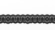 © MILON - A close up shot of black lace trim with floral and scalloped edge on a white background surface