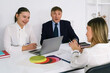 © Sergey - Team discusses project strategies in modern office environment during afternoon meeting