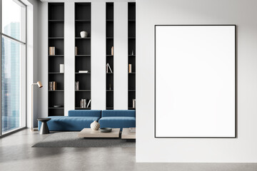 Poster - Framed blank poster mockup on white wall in modern living room with blue sofa and bookshelves near panoramic window in clean minimalist interior. 3D Rendering