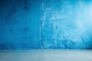 Poster - Vibrant blue textured concrete wall meets gray floor in an empty room, creating a striking backdrop