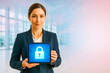 © Nargiz - Confident businesswoman holding a glowing tablet displaying a secure padlock icon, symbolizing data protection, cybersecurity, and digital privacy in a modern corporate office environment