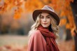 © nsit0108 - Beautiful blonde model posing in autumn park wearing stylish hat, scarf and poncho