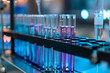 © Alberto Gonzalez  - Row of test tubes containing colorful liquids in a laboratory setting with selective focus.
