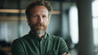© CinematicStocks - Confident mature man with beard posing in modern office space