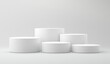 © Shahida - Five White Cylindrical Podiums of Varying Heights on a White Background Studio Shot