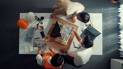 Poster - Top view of skilled architect designer team using pencil measuring house model. Group of civil engineer planning and designing blueprint while pointing at building at table with laptop. Alimentation.