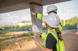 © reewungjunerr - Two engineers discuss about work at the site of large bridge under construction,Management consulting people discussion with engineers about the progress and construction planning of highway