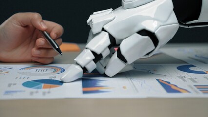 Poster - A robotic hand reaches out to interact with detailed graphs and charts, showcasing the intersection of technology and business analytics in a modern workspace.Noogenesis