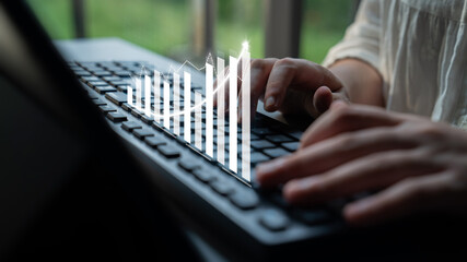 Poster - A close view of hands working on a keyboard, complemented by a digital growth chart. The image symbolizes development and finance trends in a modern workspace. Impute