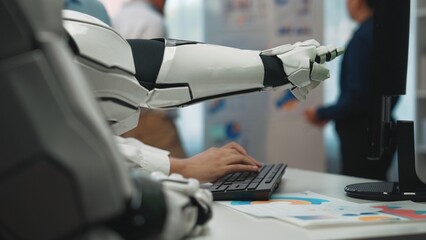 Poster - A robotic arm is seen interacting with a keyboard in a contemporary office, highlighting the synergy between advanced technology and human work.Noogenesis