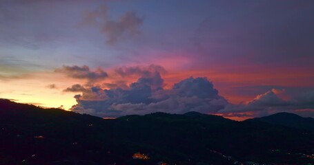 Wall Mural - 
aerial view of dramatic cloud at sunset above the coastal town. A distant hilltop structure adds a serene tranquil landscape. stock image in travel concept. sweet sky background.