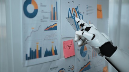 Poster - A robotic hand interacts with various data visualizations displayed on paper charts, showcasing a modern office setting focused on analysis and insights.Noogenesis