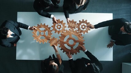 Poster - Top view of professional business team bring filled last cog to complete system. Group of smart diverse business people joining gear together at workplace.Show teamwork,unity, working. Directorate.