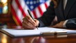 © gankevstock - Signing important documents with national flag background.