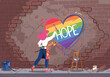 © Elzayady - Artist paints a rainbow heart with the word hope on a crumbling brick wall symbolizing resilience and optimism in challenging times fostering unity and a brighter future