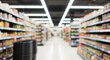 © Ivul - Blurred supermarket aisle interior, showcasing long rows of product displays. The soft focus captures the dynamic essence of modern retail and commercial shopping environments.