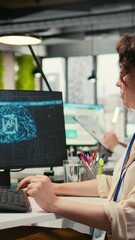Poster - Vertical Video Woman employee using AI machine learning for efficiency recognition, using a synergy of data sharing and optimization models in a co working space. IT company artificial intelligence