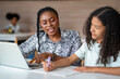 © Akarawut - African school teacher is teaching and guiding young student in the class using information from experience and internet for academic literacy study and education