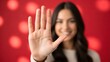 © sabrang - Woman Makes a Stop Sign Gesture with Her Hand in Focus with a Soft Background