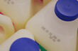 © Towfiqu Barbhuiya  - Milk containers showing expiration dates in grocery setting
