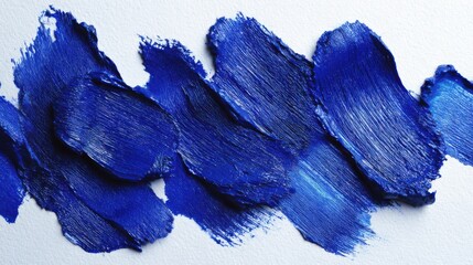 Poster - Bold blue paint strokes are artistically applied on a textured white surface, showcasing various shades and brush techniques in a creative composition.