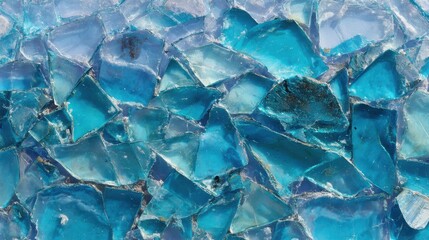 Poster - Fragments of sparkling blue glass create a vibrant mosaic. The shards exhibit a range of shades, reflecting light and casting intriguing patterns on the surface.