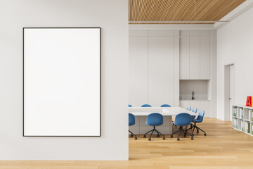 Poster - Blank vertical poster mockup on white wall in modern office interior with wood flooring, blue chairs, and clean minimal design layout. 3D Rendering