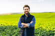 © Maria Vitkovska - Portrait of smiling farmer standing in cultivated field with arms crossed