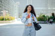 © VISTA by Westend61 - Woman using smartphone and credit card for online shopping in city