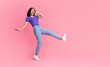 © Prostock-studio - Having Fun. Full body length shot of happy cheerful young asian woman jumping, dancing and fooling around, being in a good mood, celebrating triumph, isolated over bright pink studio background